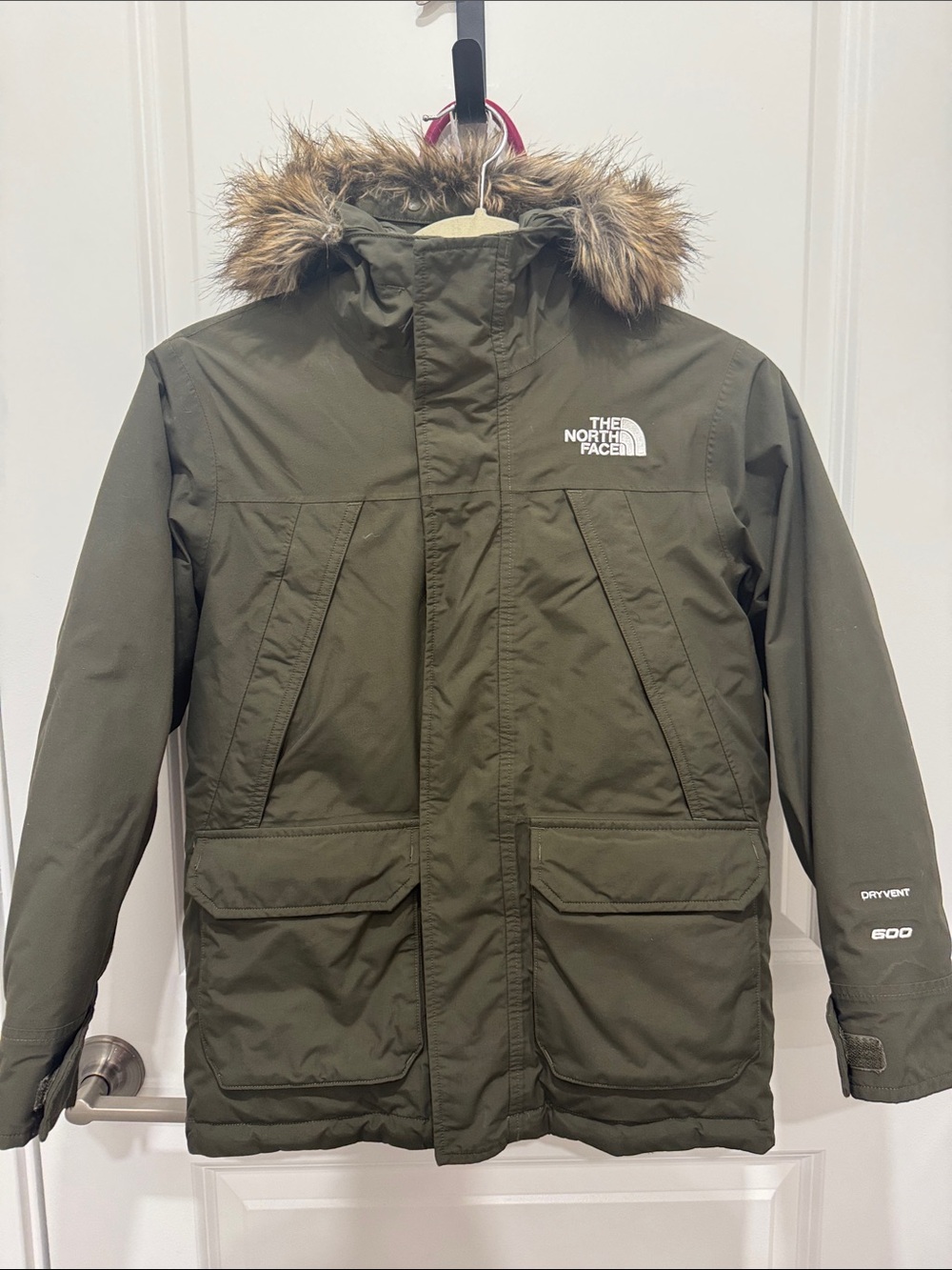 The North Face boy’s Olive Parka with Faux Fur Hood. Size medium (10) boys